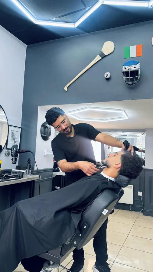 Barber trimming a beard in the chair