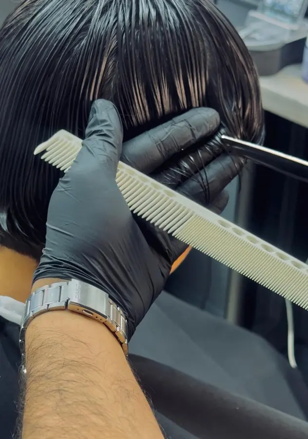 Detailed haircut close-up with comb and scissors